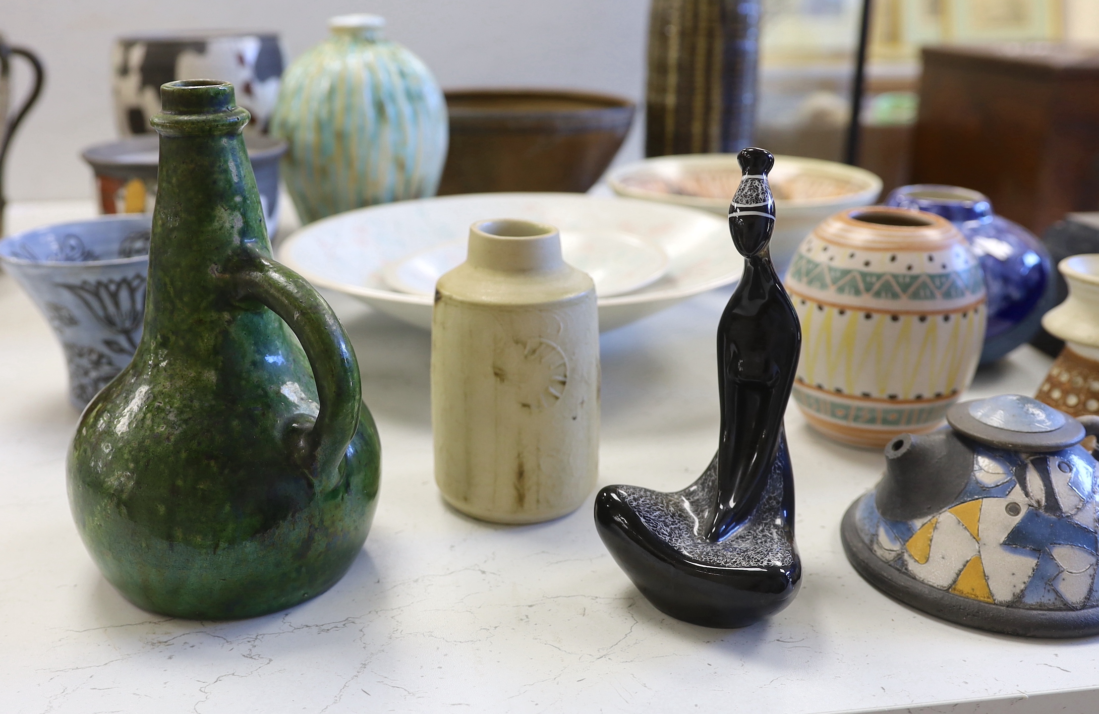 A collection of studio pottery including a Kenneth Annat Bemersyde Scottish vase, two graduated bowls and a jardiniere incised with birds, the largest 28cm high